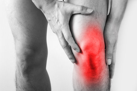 Knee pain .man standing caught his knee.  health conceptsの写真素材