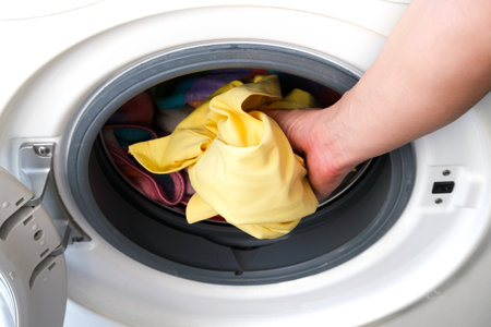 Woman's hand Pick up clothes Washing machine.Clean and Healthy Concepts.の写真素材