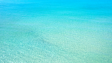 aerial view Beach background for summer vacation concept. Nature of the beach and sea, summer with sunlight, sandy beach The sparkling sea waterの写真素材