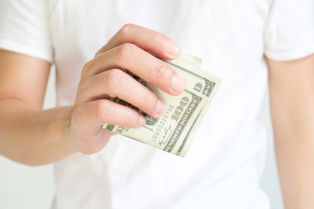Business man's hand works for the money, He offer banknotes with partner for investment business, He...