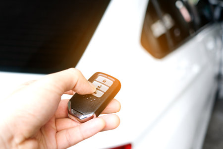 The man in the hand held the remote control of the car, he opened the remote control of the car...