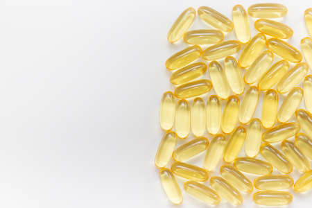 Pile of capsules Omega 3 on white background. Close-up, top view, copy space for your text. High quality photoの写真素材