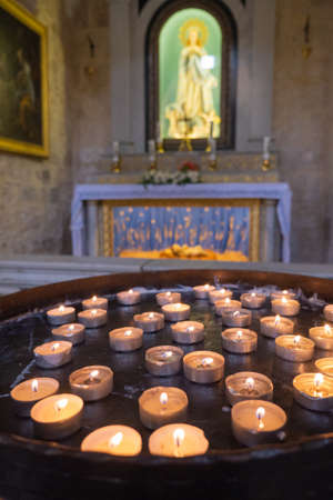 Many burning candles in church. Selective focus. High quality photoの写真素材