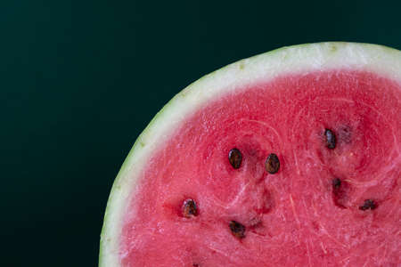 A half of fresh watermelon on dark background. Close-up macro photo. Fresh fruits textureの写真素材