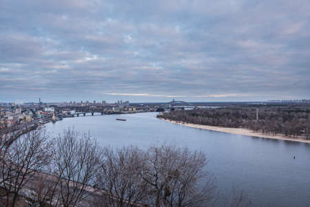 Kyiv, winter morning, beautiful view to the historical center Podol. Dnipro river, cloudy sky. High quality photo.の写真素材