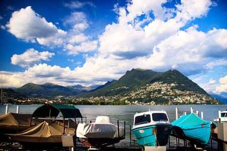 Boats on Lugano lake shore in Switzerlandのeditorial素材
