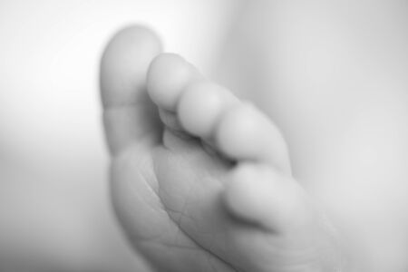 A close-up of tiny baby footの写真素材