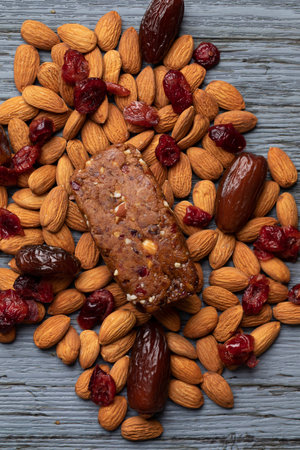 Homemade cereal bar with dried fruits and nuts on wooden backgroundの写真素材