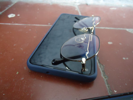 Smartphone and sunglasses on the table. Select focus. nature.の写真素材