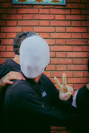 Unidentified Thai police officer in action during a protest against the government.の写真素材