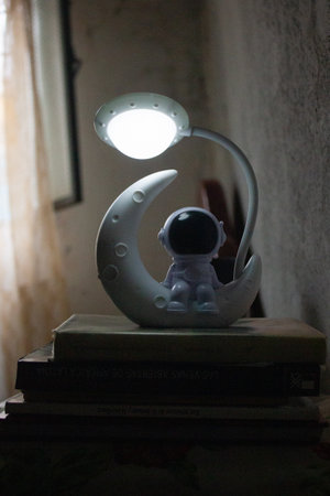 Ceramic figurine of an astronaut with a lamp in his hand.の写真素材