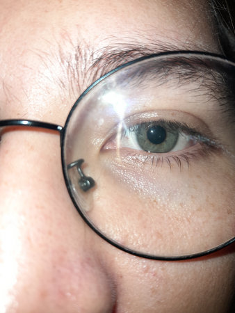 Close-up of a woman's eye with a magnifying glassの写真素材