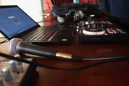 Close-up of microphone and headphones on a dj's desk.の写真素材