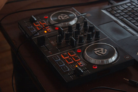 Close up of professional dj mixer on dark wooden background. Select focus.の写真素材