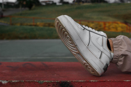 Pair of white sneakers on the ground at the skate park.の写真素材