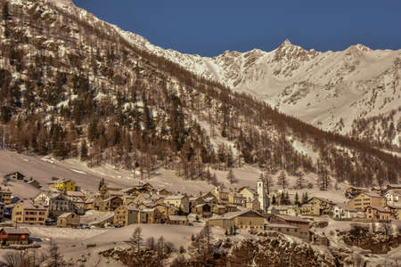 Little town at the top of a snowed mountain in Switzerland, Europe, on a sunny day