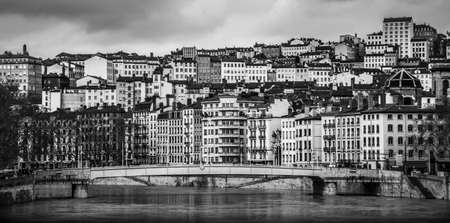 A lot of houses over the river from a bridge in Lyon, France. Black and white shot.のeditorial素材