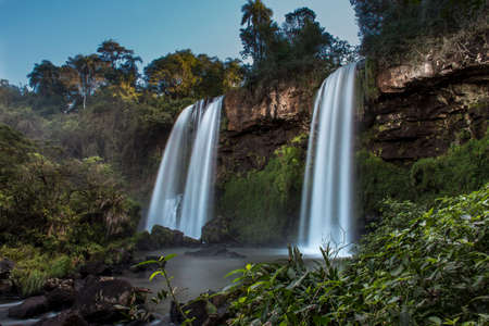 twin water drops in Cataratas del IguazÃº National Park, called Sister Junps (Salto dos Hermanas) between the jungle forest in IguazÃº, Misiones, Argentina with a rainbow.の写真素材
