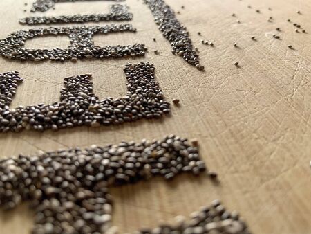 Healthy Food written with chia and oats on a wooden board. Vegetable banner.の写真素材