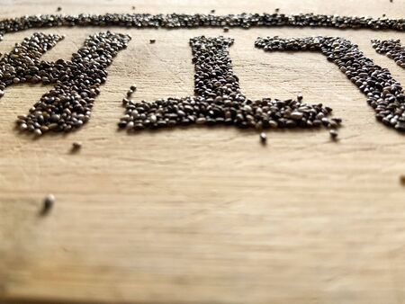 Healthy Food written with chia and oats on a wooden board. Vegetable banner.の写真素材