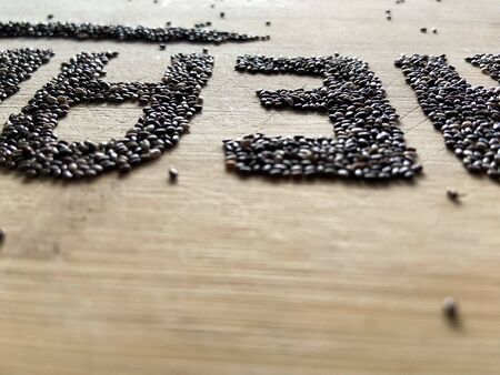 Healthy Food written with chia and oats on a wooden board. Vegetable banner.の写真素材