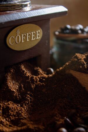 still life with coffee beans and old coffee mill on the rustic backgroundの写真素材