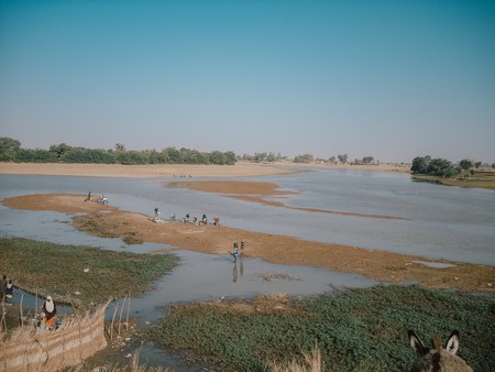 Timbuktu, Mali, Africa - February 3, 2008: View of the Niger River with workers on its shore.のeditorial素材