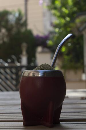 Mate Herbs Drink traditional from Argentina, Straw. With Calabash on wooden table.の写真素材