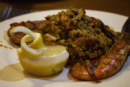 Served plate of mixed paella with shrimp and mussels. Typical of Valencia.の写真素材