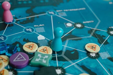 Playing a game of pandemic legacy. Game that simulates a global pandemic and how to stop it. A game suitable for all lovers of conspiracies.の写真素材