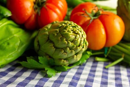 Tomato beef heart over artichokes, chard and fennel. Natural raw food. Slow food.の写真素材