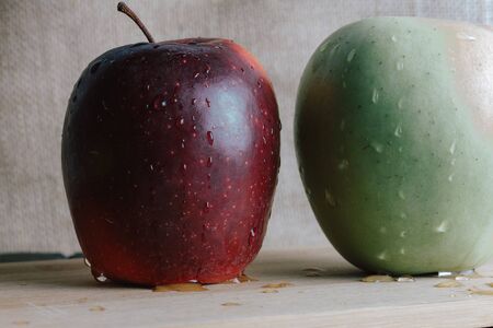two different apples on slate and rustic backgroundの写真素材