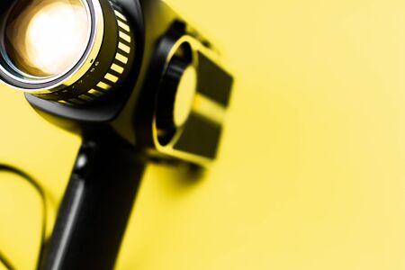 8 Mm Camera Retro Film Reel in a yellow color backgroundの写真素材
