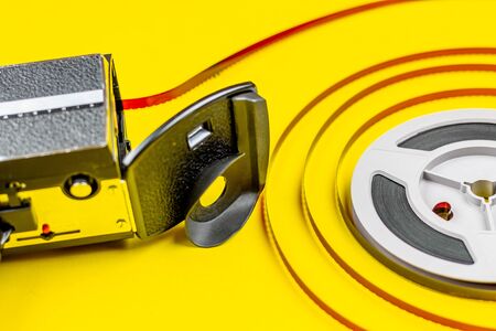 8 Mm Camera Retro Film Reel in a color background, concept of film education and video editing