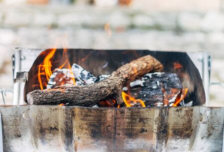Homemade barbecue with burning wood. Concept of making a fire at home.の写真素材