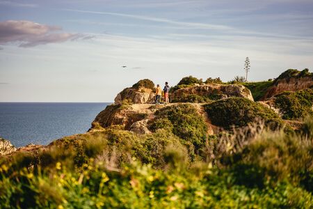 Couple standing on a headland at Ponta da Piedadeの写真素材