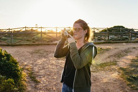Young woman tourist talking photographsの写真素材