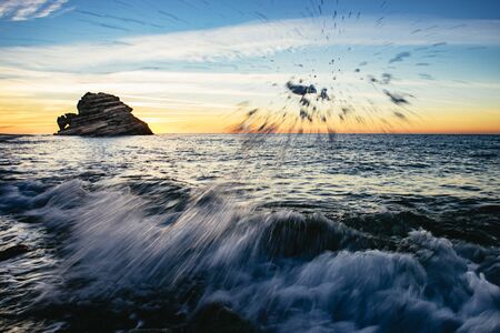 Splashing surf and breaking waves at sunsetの写真素材