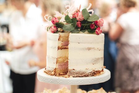 Layered cake on a dessert stand on a buffet table