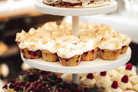Display stand with fruity meringue cupcakesの写真素材