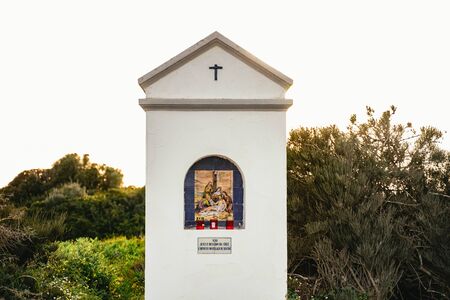 Small white religious shrine with decorative tileの写真素材