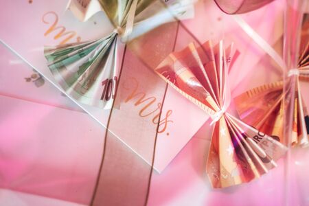 Abstract pink collage intended for newlyweds. Folded euro banknotes various value. Wedding day concept.の写真素材