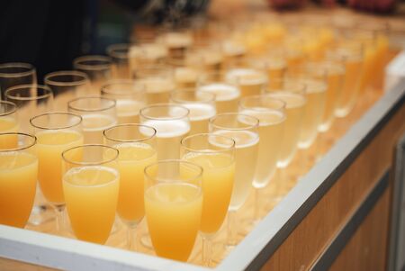 Rows of glasses with various colorful drinks standing on buffet table. Celebration, birthday, party, wedding concept.の写真素材