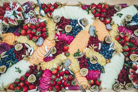 Top view of colorful buffet table with various fresh fruits and vegetables. Flat lay composition....