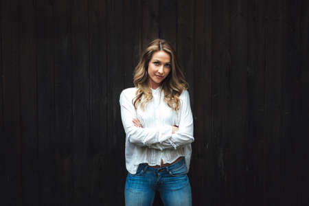 portrait of confident woman wooden backgroundの写真素材