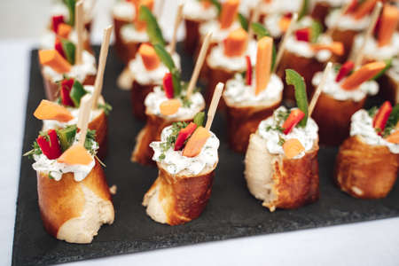 Close up of pretzel with vegetables and cream at wedding partyの写真素材