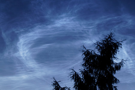 View of noctilucent clouds on evening blue skyの写真素材