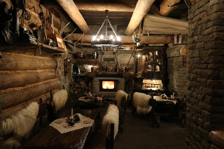 View of an old wooden and stone highlander chamber with a fireplaceの写真素材
