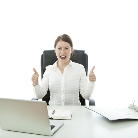 young brunette business woman thumb up on deskの写真素材