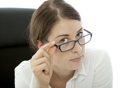 young brunette business woman squint over glasses on white backgroundの写真素材